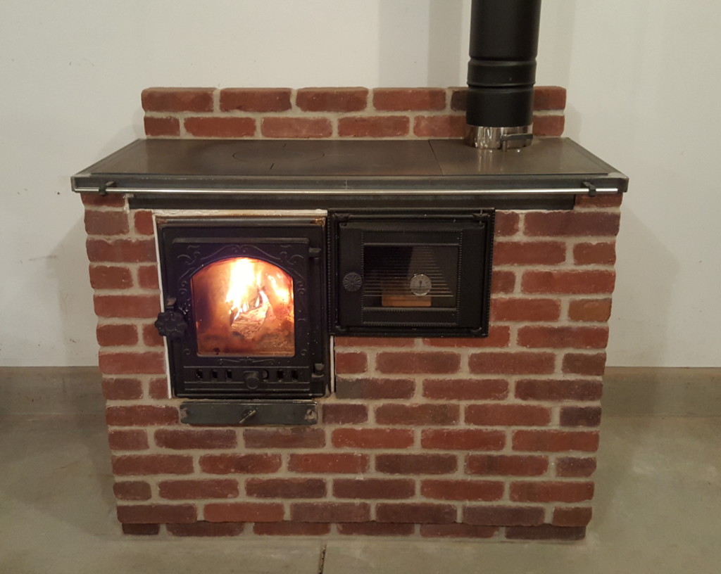 The Cabin Stove - a small masonry heater and cook stove combination.