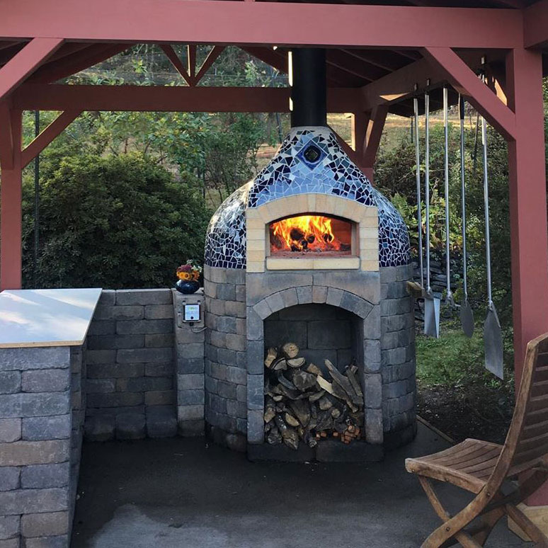Custom outdoor kitchen with wood-fired oven